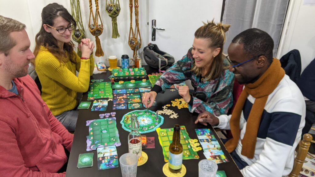 Quatre joueurs jouent au jeu de société Living Forest.
